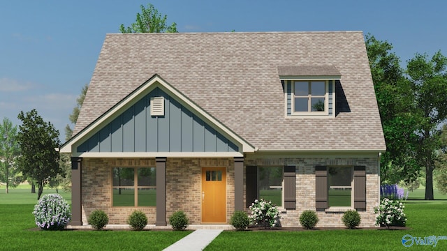 view of front of property with brick siding, board and batten siding, a front lawn, and roof with shingles