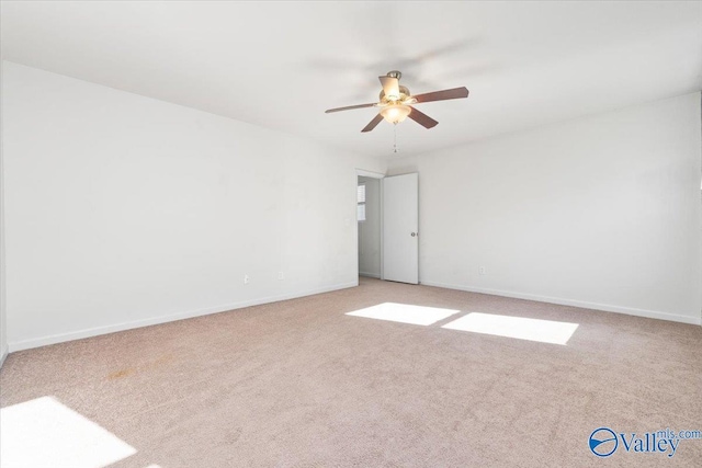 carpeted spare room featuring ceiling fan