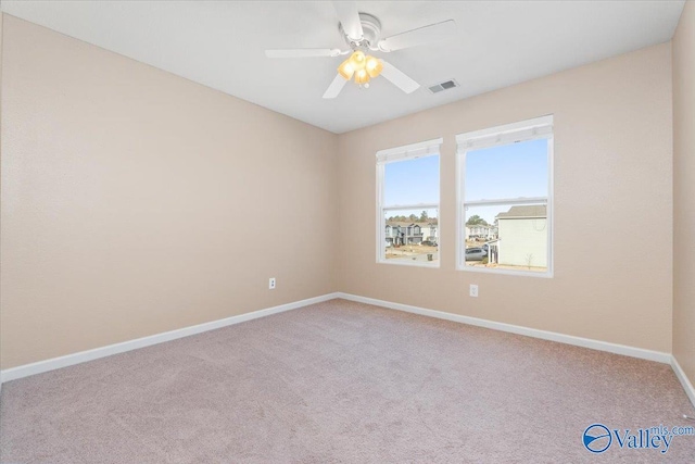 carpeted empty room featuring ceiling fan