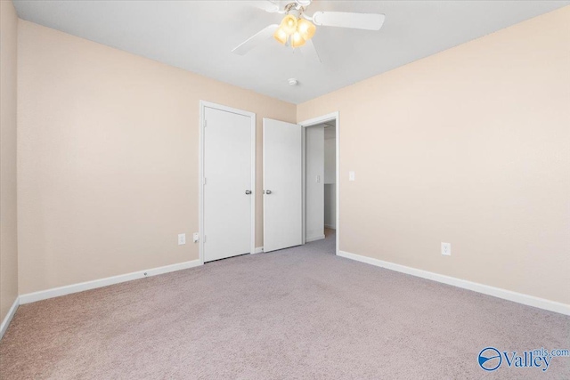 unfurnished bedroom featuring ceiling fan and light carpet