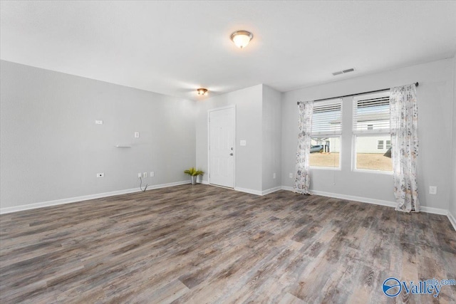 empty room featuring wood-type flooring