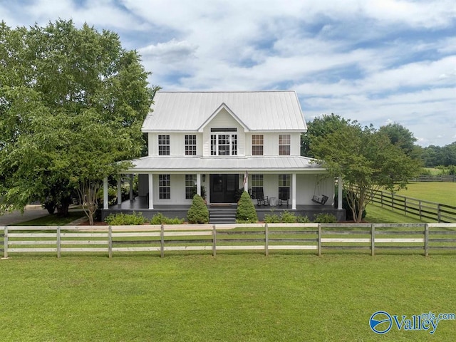 farmhouse-style home featuring a porch, a front lawn, and a rural view