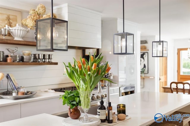 kitchen with white cabinetry and hanging light fixtures