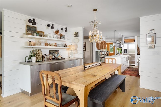 dining area featuring a notable chandelier and light hardwood / wood-style floors