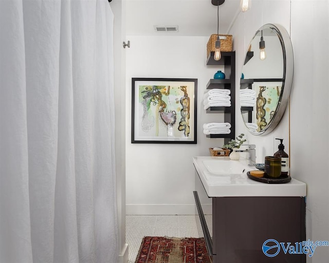 bathroom with tile patterned flooring and vanity