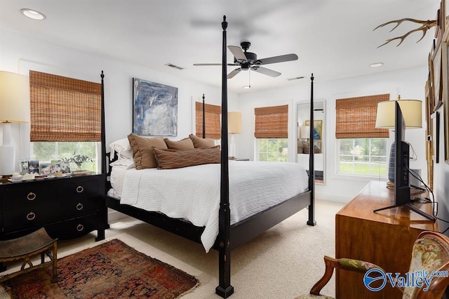 bedroom featuring light colored carpet and ceiling fan