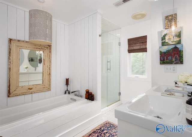 bathroom featuring separate shower and tub and sink