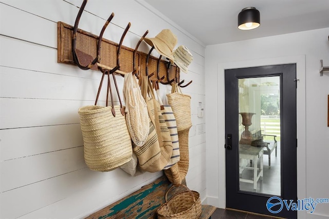 mudroom with wooden walls