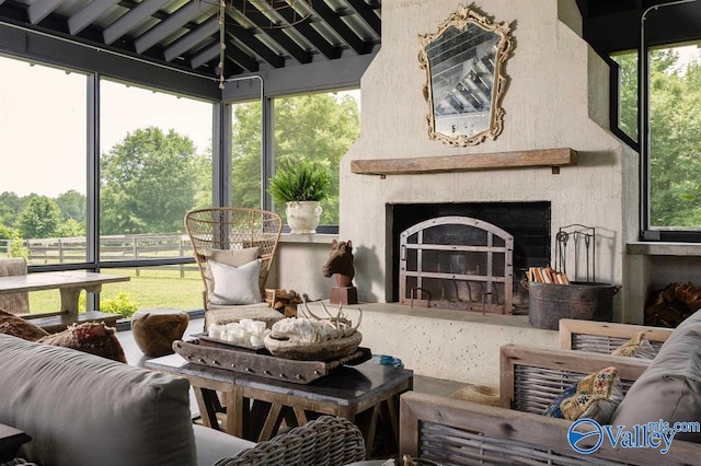 sunroom with a fireplace and plenty of natural light