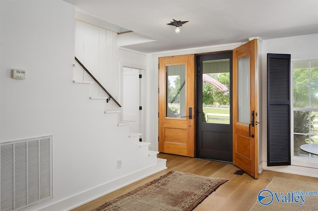 foyer featuring a wealth of natural light and light hardwood / wood-style floors