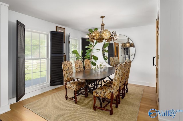 dining area featuring an inviting chandelier and hardwood / wood-style floors