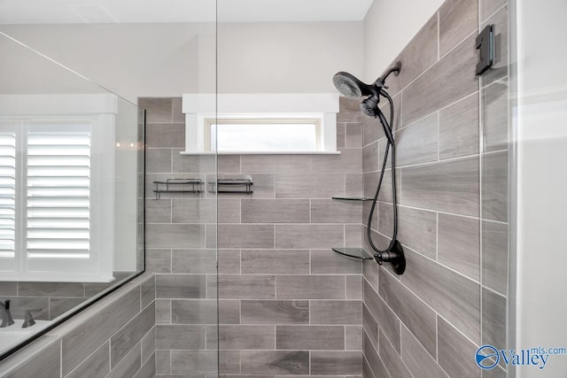 bathroom with a tile shower