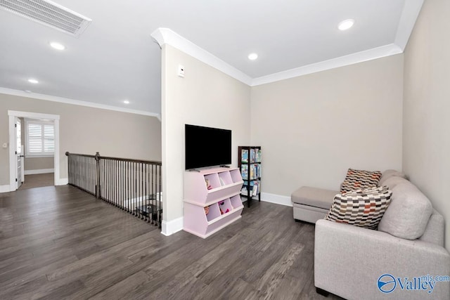 living area featuring ornamental molding, dark wood-style flooring, visible vents, and baseboards