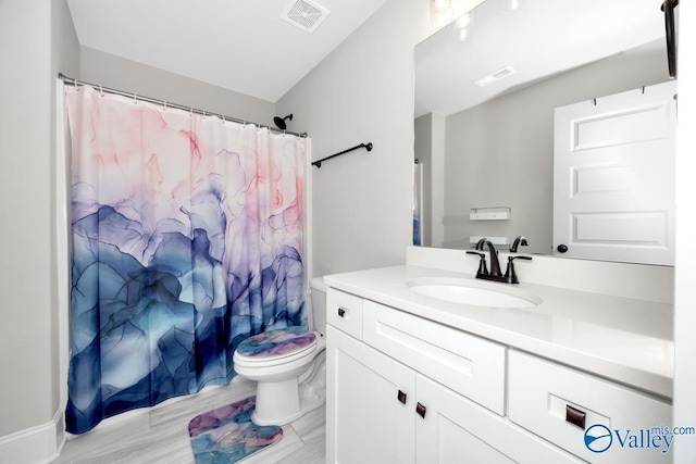 bathroom featuring toilet, a shower with shower curtain, vanity, and visible vents