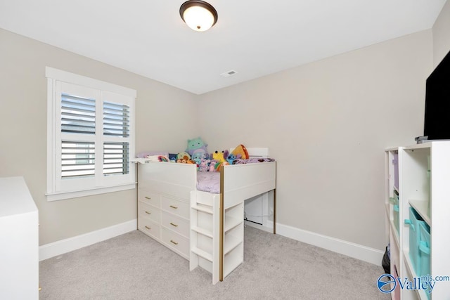 bedroom with visible vents, baseboards, and light colored carpet