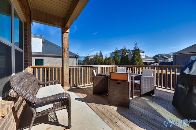 deck featuring a residential view and outdoor dining area