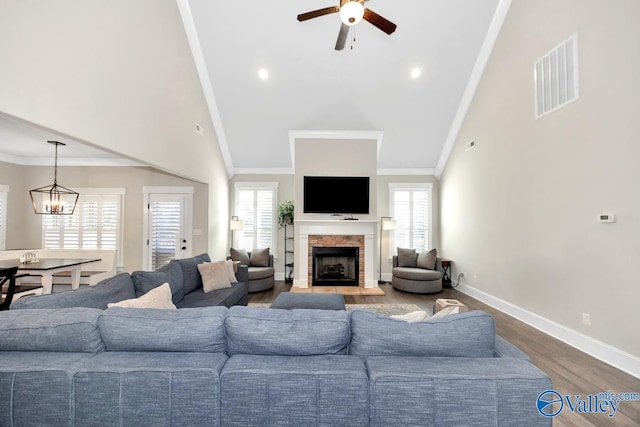 living area with ornamental molding, a healthy amount of sunlight, and visible vents