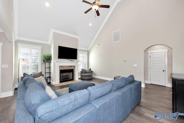 living area featuring a wealth of natural light, visible vents, crown molding, and wood finished floors