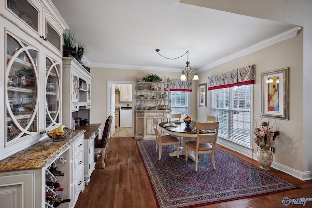 dining area featuring ornamental molding, dark wood-style flooring, baseboards, and an inviting chandelier