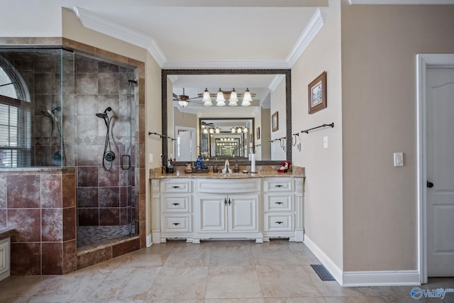 full bathroom with ceiling fan, vanity, baseboards, ornamental molding, and a shower stall