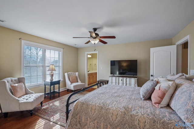 bedroom featuring ceiling fan, connected bathroom, wood finished floors, visible vents, and baseboards