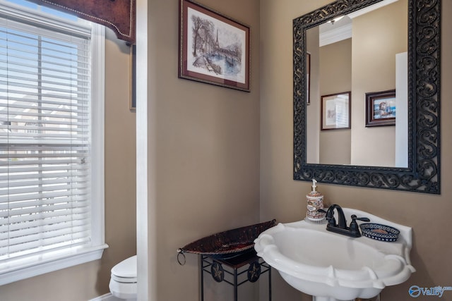 bathroom with toilet and a sink