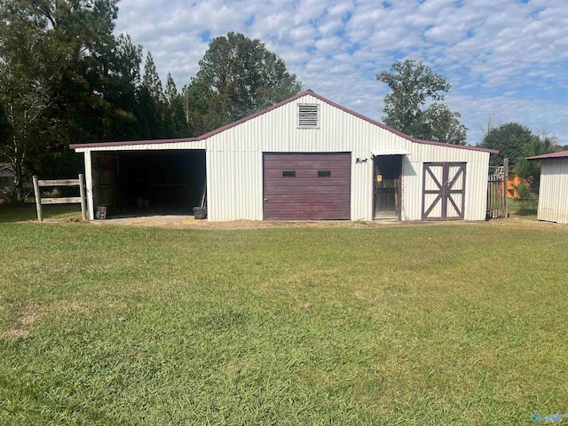 view of outbuilding with a lawn and a garage