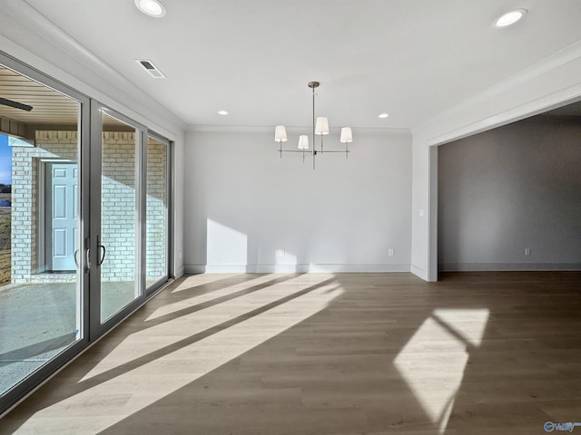 spare room with baseboards, wood finished floors, and recessed lighting