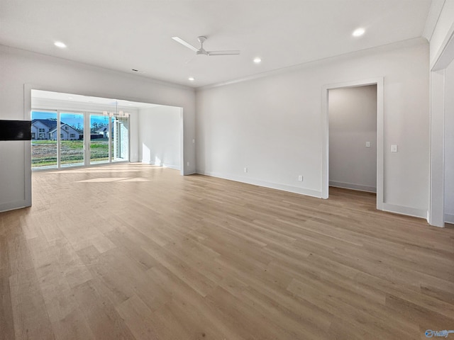 unfurnished living room featuring recessed lighting, light wood-style flooring, baseboards, and ceiling fan with notable chandelier