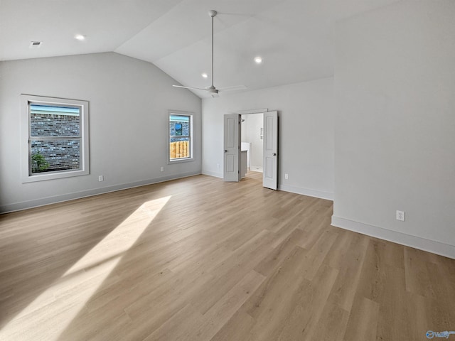 unfurnished bedroom featuring recessed lighting, light wood-style floors, connected bathroom, vaulted ceiling, and baseboards