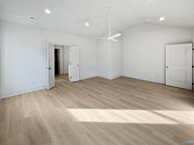 empty room featuring light wood finished floors, recessed lighting, visible vents, vaulted ceiling, and baseboards