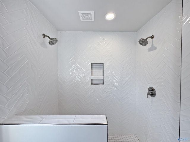 bathroom featuring visible vents and tiled shower