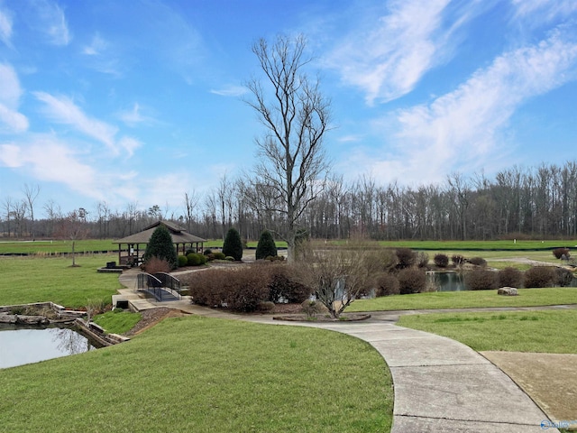 surrounding community featuring a gazebo, a yard, and a water view