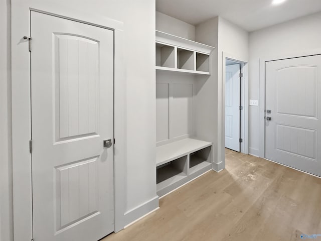 mudroom with baseboards and wood finished floors