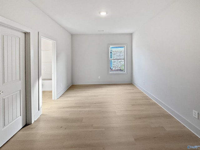 interior space featuring light wood-style flooring and baseboards