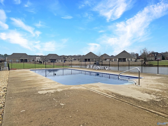 view of swimming pool featuring a water view and a patio area