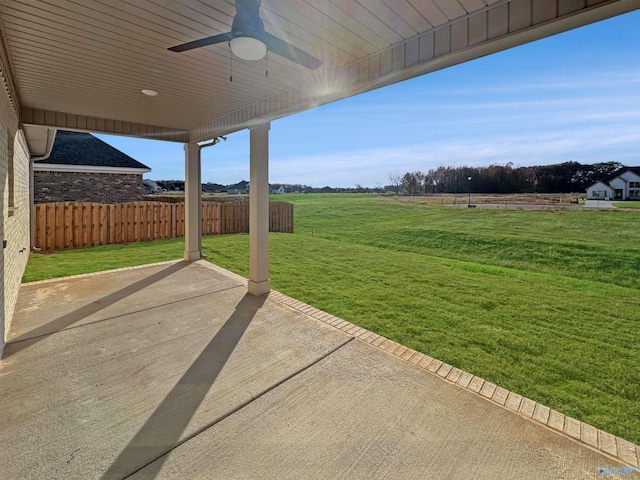 view of patio featuring a ceiling fan and fence