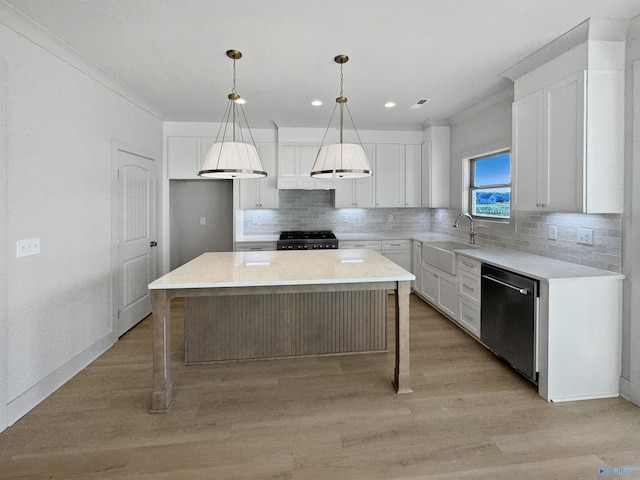 kitchen with a sink, stove, white cabinets, and stainless steel dishwasher