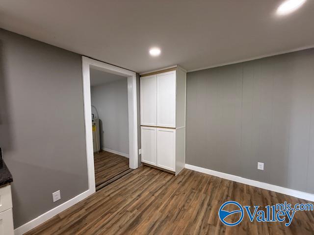finished below grade area featuring dark wood-style flooring and baseboards