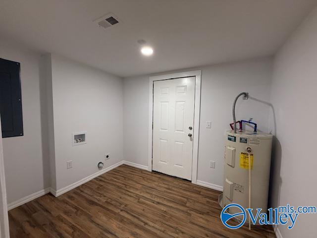 clothes washing area featuring hookup for an electric dryer, washer hookup, visible vents, water heater, and wood finished floors
