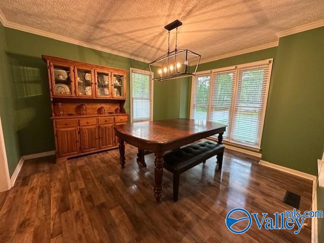 dining area with a textured ceiling, baseboards, an inviting chandelier, and dark wood finished floors