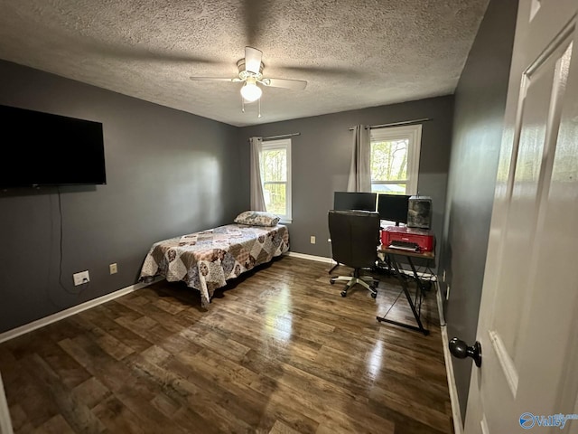 bedroom featuring wood finished floors, a textured ceiling, baseboards, and ceiling fan