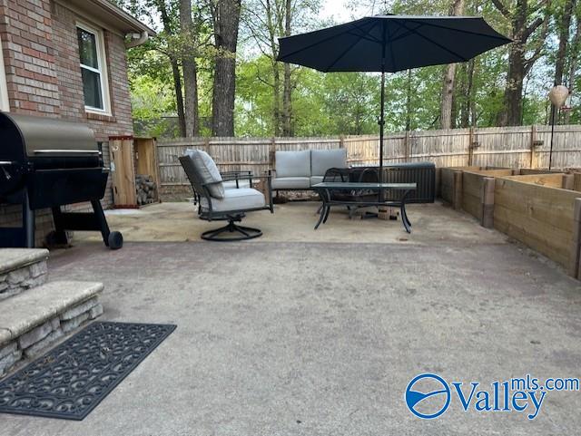 view of patio / terrace featuring area for grilling, an outdoor hangout area, and a fenced backyard