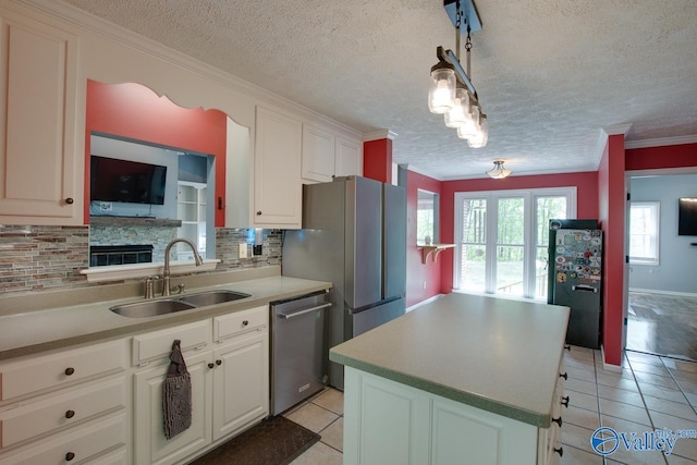 kitchen with a sink, a textured ceiling, decorative backsplash, dishwasher, and light tile patterned floors