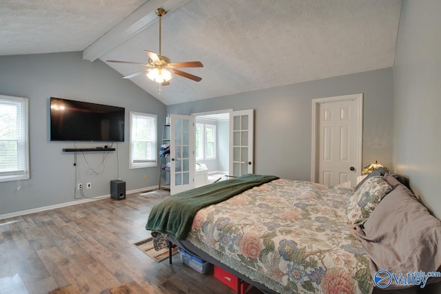 bedroom featuring wood finished floors, vaulted ceiling with beams, a ceiling fan, french doors, and a textured ceiling