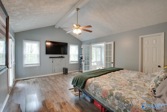 bedroom with french doors, wood finished floors, a textured ceiling, and multiple windows
