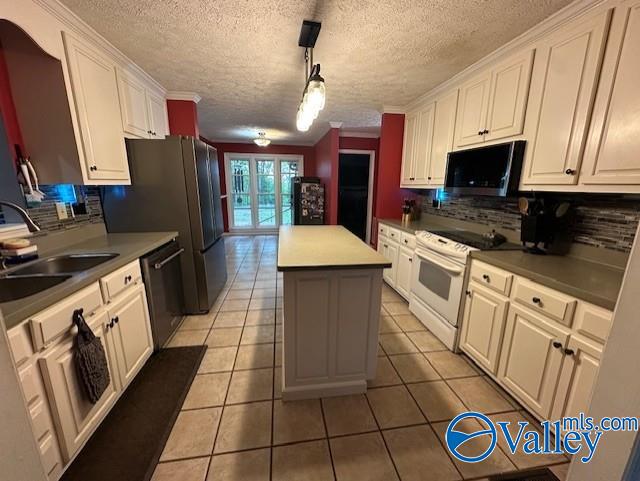 kitchen with electric range, a center island, dishwasher, a sink, and backsplash
