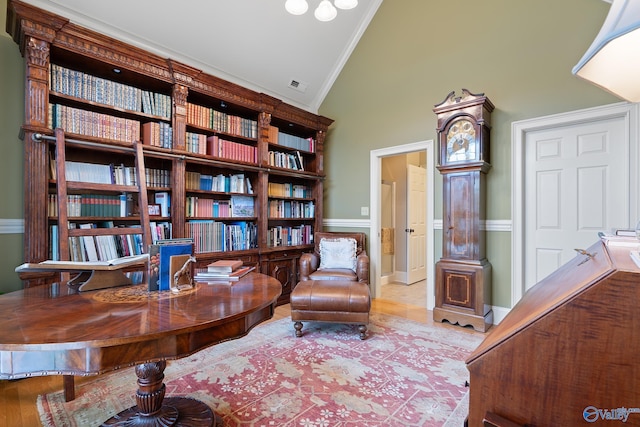 living area with high vaulted ceiling, visible vents, and ornamental molding
