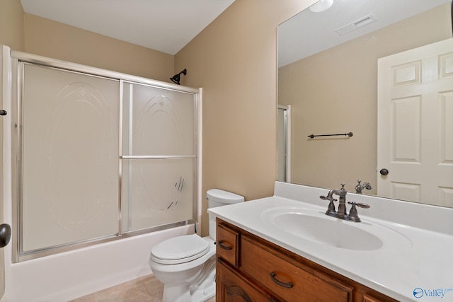 full bath with vanity, enclosed tub / shower combo, tile patterned flooring, toilet, and visible vents
