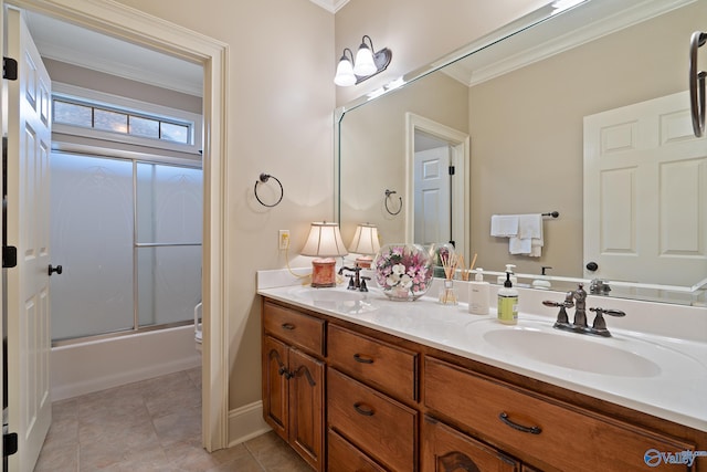 bathroom featuring tile patterned floors, double vanity, a sink, and crown molding